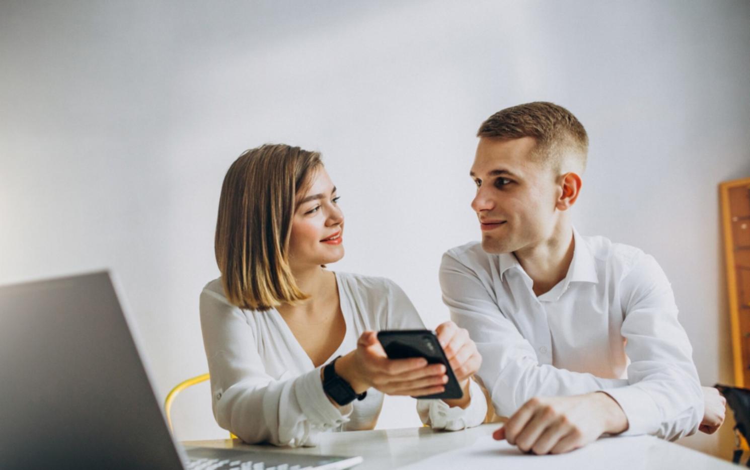Team meeting reviewing budget performance charts and risk assessment reports